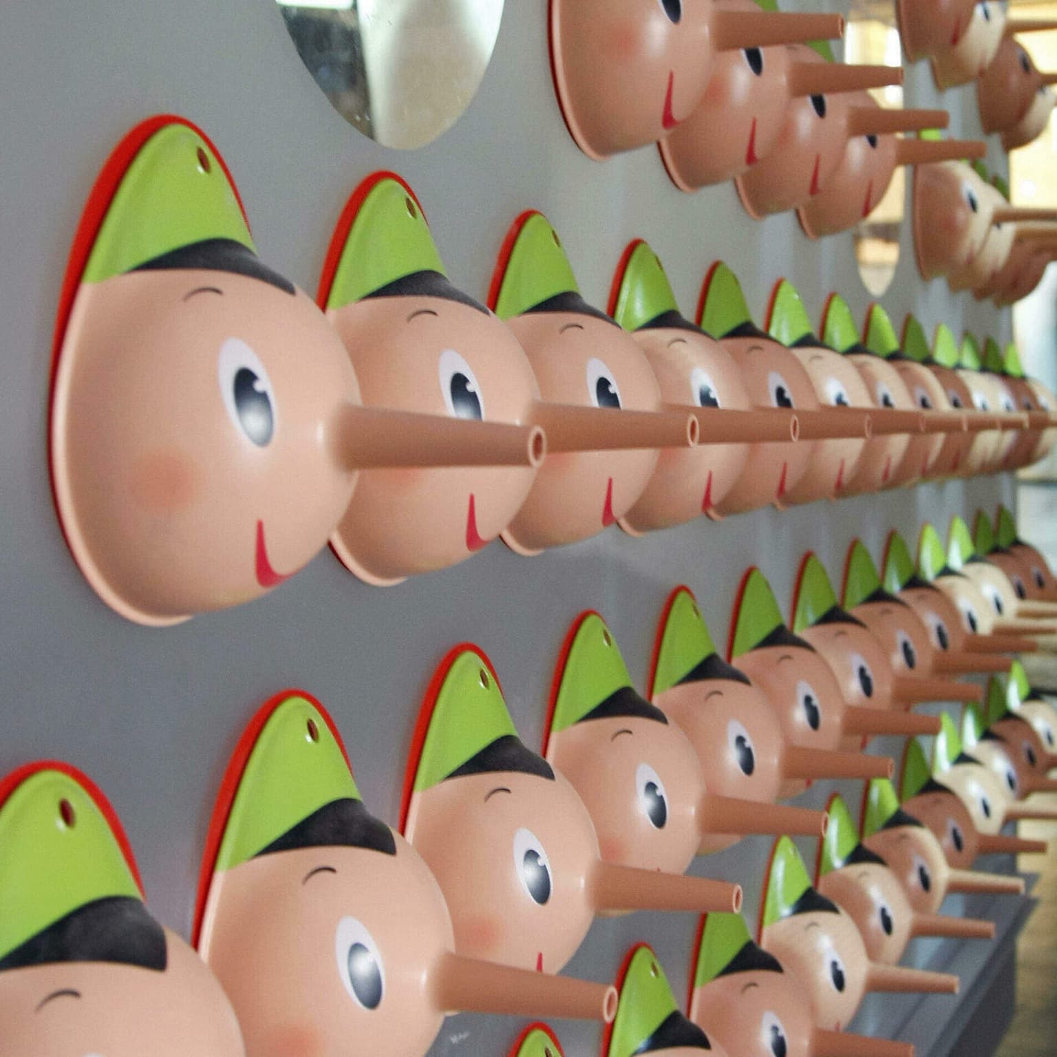 A fact checker hangs up his Pinocchios artwork
